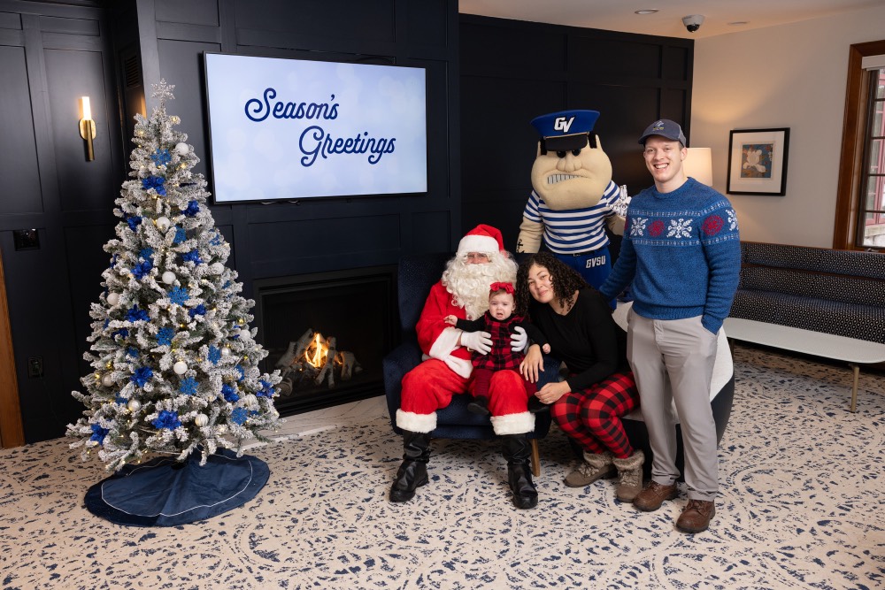 Crying baby on Santa's lap with mom and dad